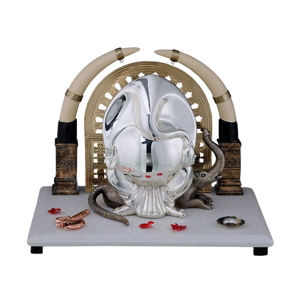 Ganesh Gaja Mukh Asura is a sterling silver Ganesha idol that rises as an abstracted elephant-face form from a fluted base – Small
