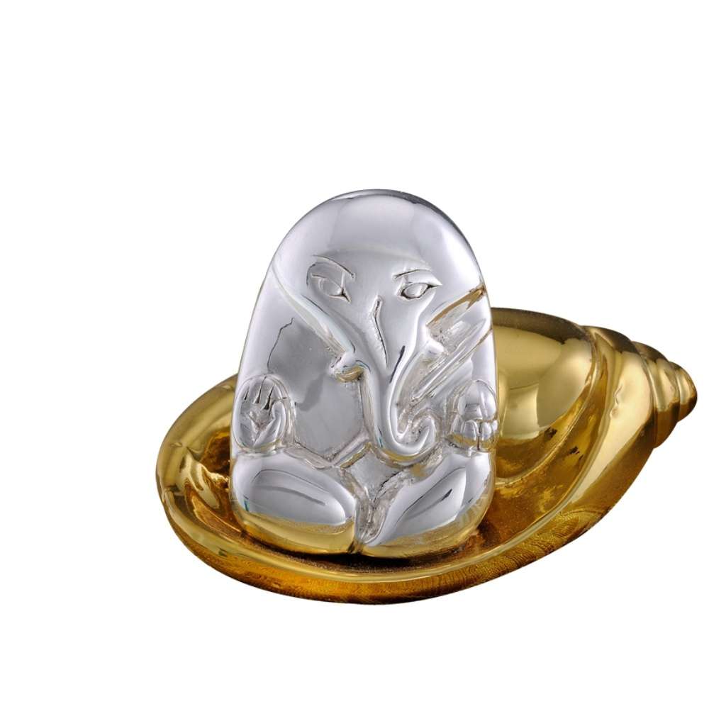 Ganesh Shell sets a miniature, minimalist sterling silver Ganesha head and torso atop a gleaming gold-toned conch shell, or shankh – Small